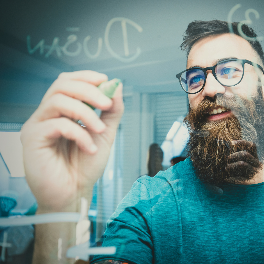 man writing on glass