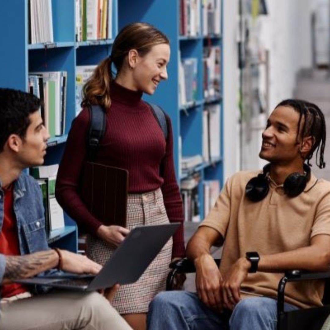 Image of 3 students, to sat and one standing