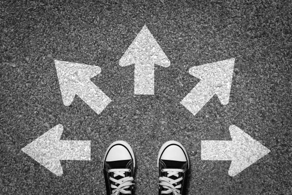image of a pair of feet with arrows marked in different directions on the floor