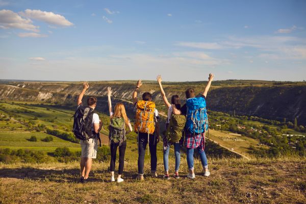 image of a group of travellers with their backs to the camera facing the journey ahead