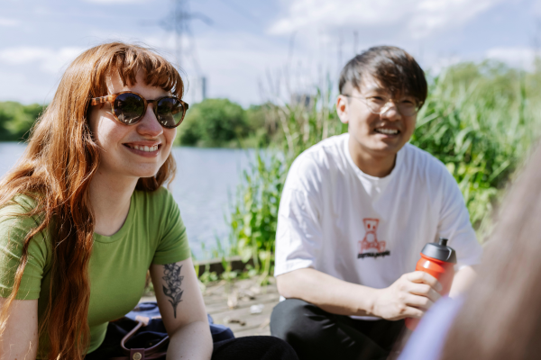 Image of people sat outside smiling