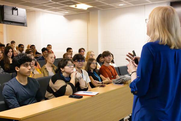 A lecturer speaks to her audience.