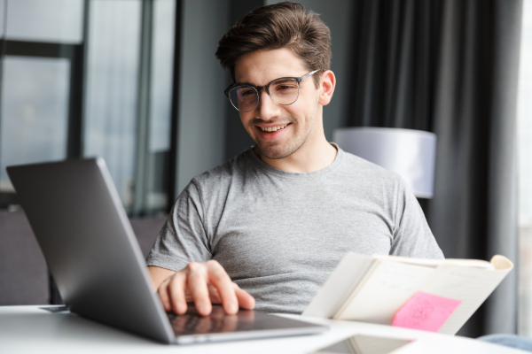 image of man sat at laptop