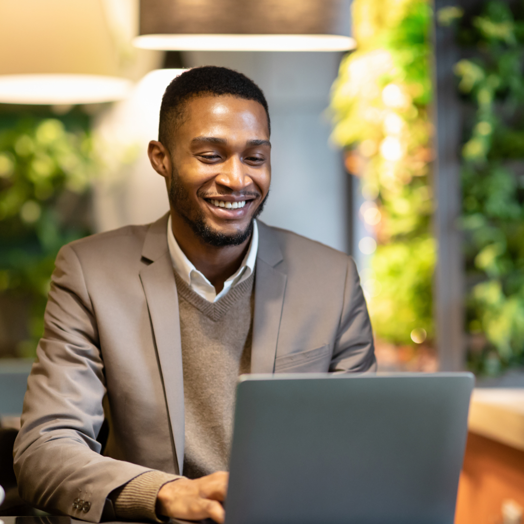 Image of man sat using a laptop