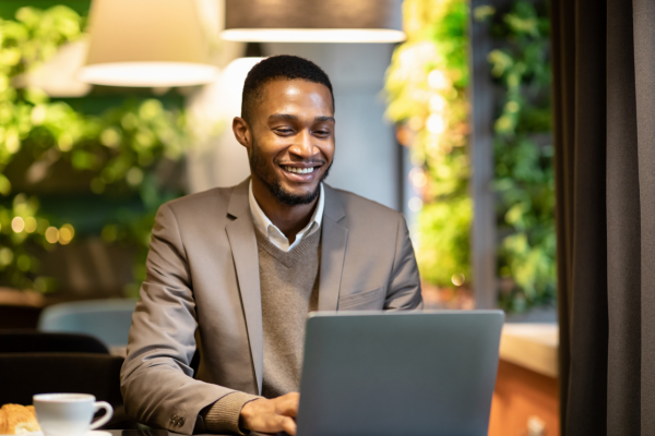 Image of man sat using a laptop