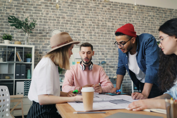 Image of students in discussion around a table