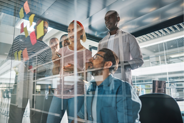 Image of group of people collaborating on a learning board
