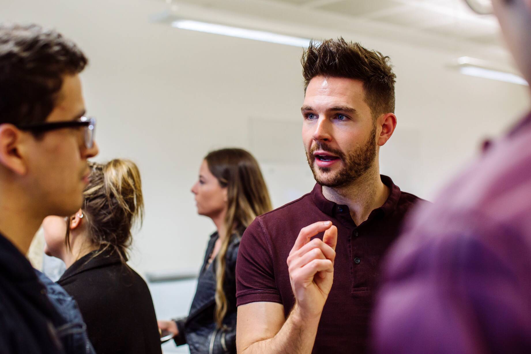 Image shows a gentleman talking with placement students