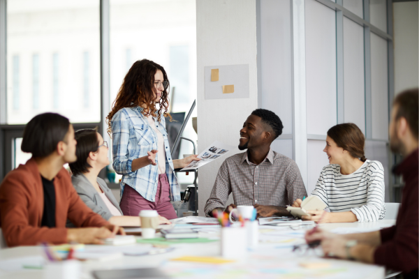 image of group of people in discussion around a table