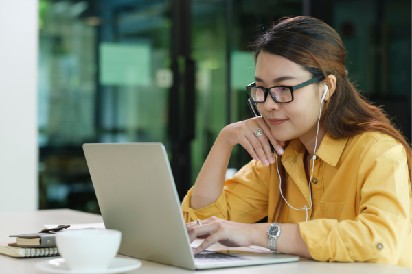 Image of woman sat looking at a laptop