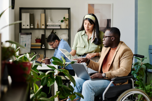 Image of student in wheelchair talking to academic