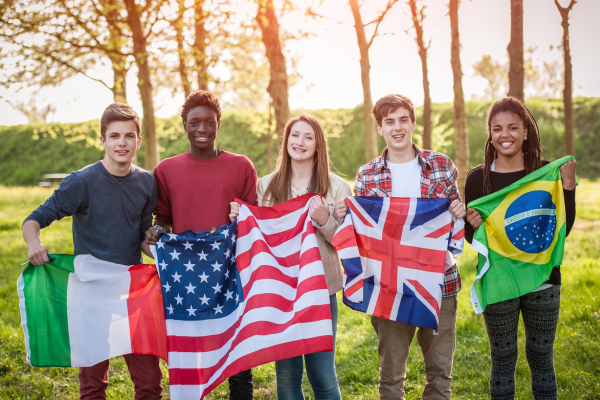 Image of group of students stood, holding flags