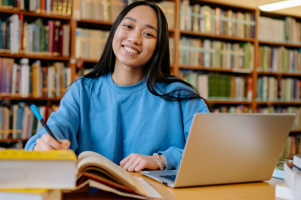Image of student in library setting studying