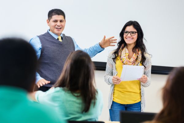 Image of two people presenting to class