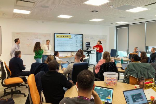 People in room presenting and discussing