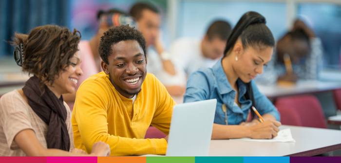 image of students chatting and working on laptop