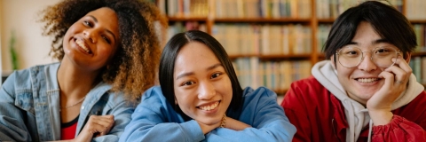 Image of three students smiling at camera